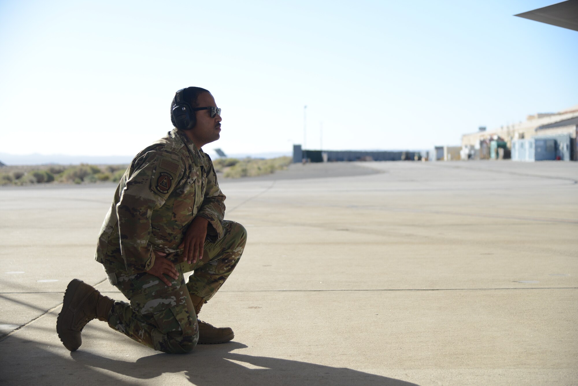 Capt. Ian Myles, F-35 Aircraft Maintenance Unit Officer-in-Charge , 31st Test and Evaluation Squadron, stands by as an F-35 Lightning II, prepares to take off from Edwards Air Force Base, California, for the final time, Oct. 7. The 31st TES recently completed its initial operational test and evaluation mission and six F-35s were reassigned to the 422nd Test and Evaluation Squadron at Nellis Air Force Base, Nevada.  (U.S. Air Force photo by Giancarlo Casem)