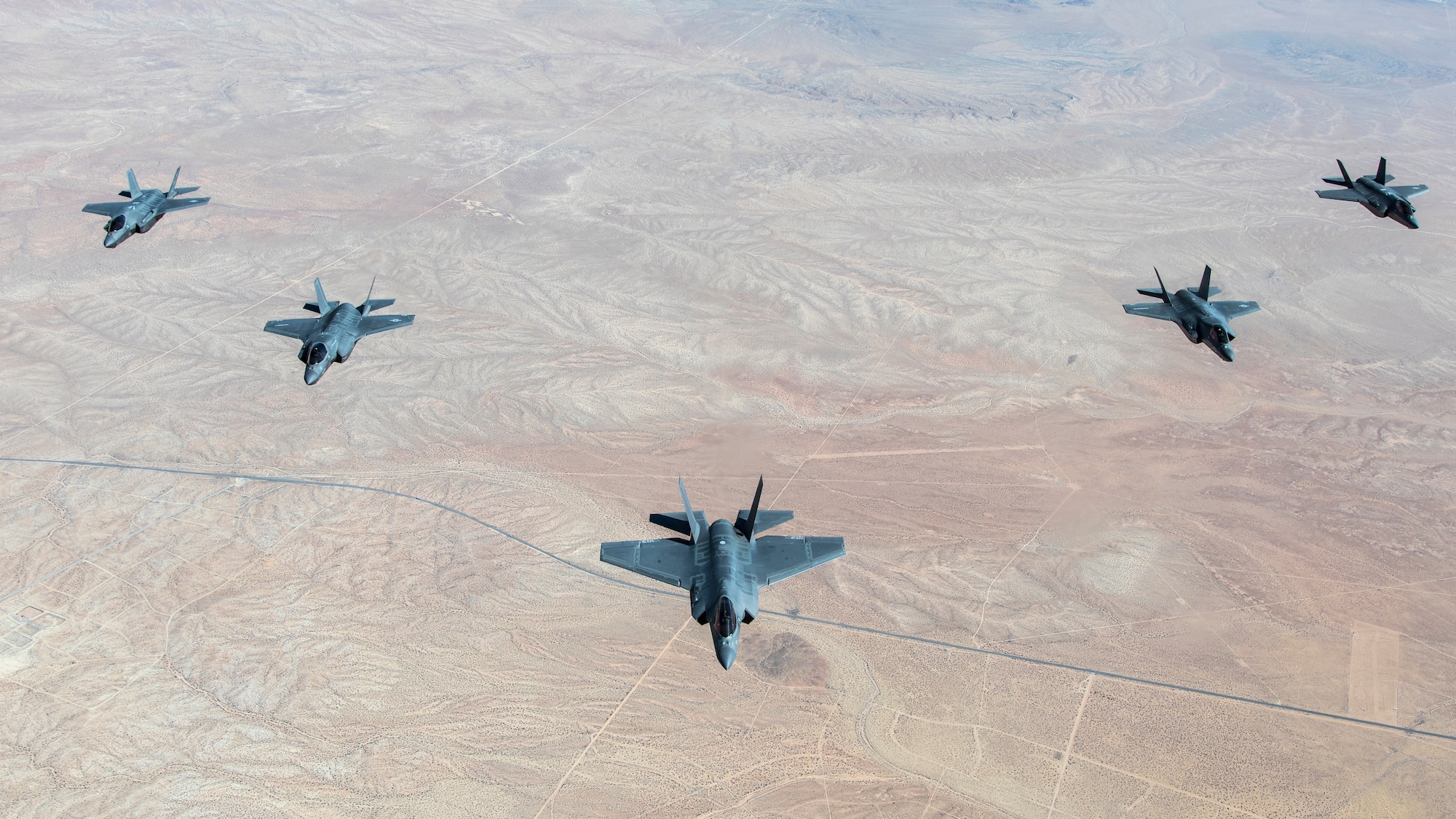 A formation flight of F-35 Lightning IIs over Edwards Air Force Base, California. The 31st Test and Evaluation Squadron recently completed its initial operational test and evaluation mission and six F-35s were reassigned to the 422nd Test and Evaluation Squadron at Nellis Air Force Base, Nevada. (Photo courtesy of Darin Russell, Lockheed Martin)