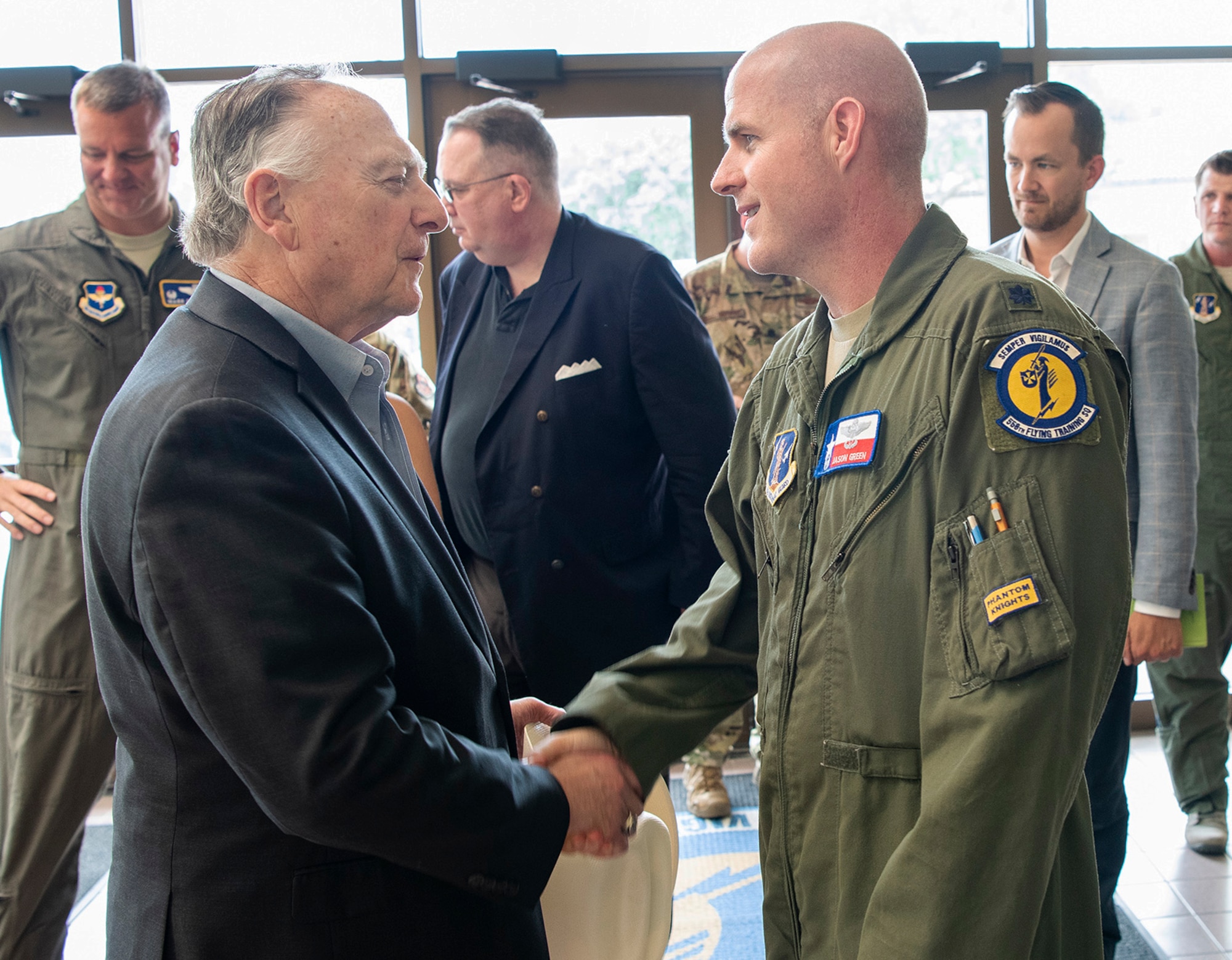 Photo of Texas State Representative Dan Flynn shaking hands with Lt. Col. Jason Green, Texas Air National Guard 147th Operation Group Detachment 1 commander inside the foyer of the 558th Flying Training Squadron.