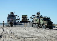 U.S. Marines with 2nd Transportation Support Battalion (TSB), Combat Logistics Regiment 2, 2nd Marine Logistics Group, load equipment on Landing Craft, Air Cushions (LCAC) 69 and 53, assigned to Assault Craft Unit (ACU) 4, during Type Commander Amphibious Training (TCAT) 20.1 on Onslow Beach, Camp Lejeune, North Carolina, Oct. 21-26, 2019. TCAT is a mobility exercise ashore in order to gain the requisite skills and experience to integrate with the U.S. Navy in follow on exercises and real-world operations.