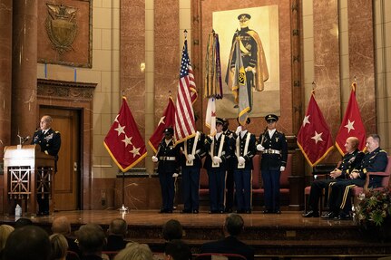 Gen. Gustave F. Perna, U.S. Army Materiel Command commanding general, left, delivers his remarks shortly after transferring command of the U.S. Army Financial Management Command from Maj. Gen. David C. Coburn, seated left, to Brig. Gen. Mark S. Bennett, far right, during a ceremony at the Indiana War Memorial in Indianapolis, Oct. 25, 2019. Coburn, the highest ranking service member stationed in Indiana, retired in a ceremony after the event, bringing his 37-year military career to a close. (U.S. Army photo by Mark R. W. Orders-Woempner)