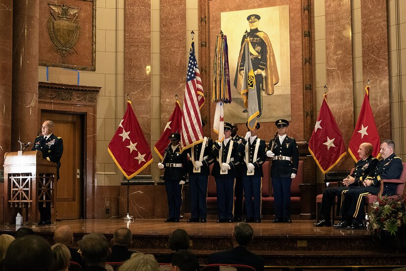 Gen. Gustave F. Perna, U.S. Army Materiel Command commanding general, left, delivers his remarks shortly after transferring command of the U.S. Army Financial Management Command from Maj. Gen. David C. Coburn, seated left, to Brig. Gen. Mark S. Bennett, far right, during a ceremony at the Indiana War Memorial in Indianapolis, Oct. 25, 2019. Coburn, the highest ranking service member stationed in Indiana, retired in a ceremony after the event, bringing his 37-year military career to a close. (U.S. Army photo by Mark R. W. Orders-Woempner)