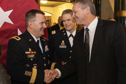 Greg Schmalfeldt, Defense Finance and Accounting Service Indianapolis director and Army client executive, right, congratulates Brig. Gen. Mark S. Bennett shortly after Bennett took command of the U.S. Army Financial Management Command during a ceremony at the Indiana War Memorial in Indianapolis, Oct. 25, 2019. USAFMCOM’s mission is to conduct enterprise-level financial operations and provide technical coordination for finance and comptroller units and commands across the Army in order to ensure the effective implementation of policies and programs to support, optimally resourcing the Army. (U.S. Army photo by Mark R. W. Orders-Woempner)
