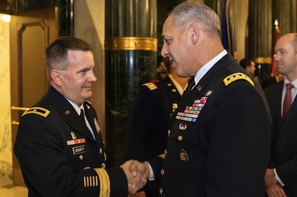 Gen. Gustave F. Perna, U.S. Army Materiel Command commanding general, right, congratulates Brig. Gen. Mark S. Bennett shortly after Bennett took command of the U.S. Army Financial Management Command during a ceremony at the Indiana War Memorial in Indianapolis, Oct. 25, 2019. The change of command was the first formal event for USAMCOM since its move under AMC earlier in the month. (U.S. Army photo by Mark R. W. Orders-Woempner)