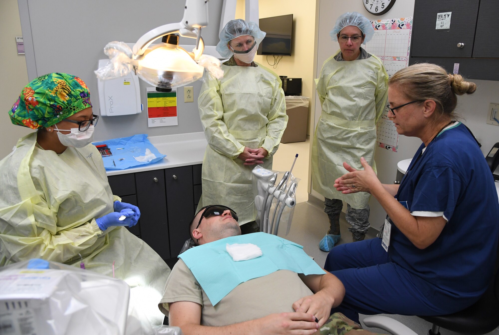 U.S. Air Force Lt. Col. Jill Cherry, 81st Dental Squadron dentist, explains dental exam procedures to 81st Medical Group leadership at the dental clinic inside the Keesler Medical Center at Keesler Air Force Base, Mississippi, Sept. 17, 2019. The "Dragon Medic Experience" allowed the 81st MDG leadership to work side-by-side with group medics in order to understand the challenges and barriers they may face while providing care. It also allowed them to see first-hand the great ideas that the staff has implemented to focus on the patient experience. This experience helps us cultivate an environment where senior leadership has direct engagement and connection with our front line medics who strive to deliver outstanding care. (U.S. Air Force photo by Kemberly Groue)