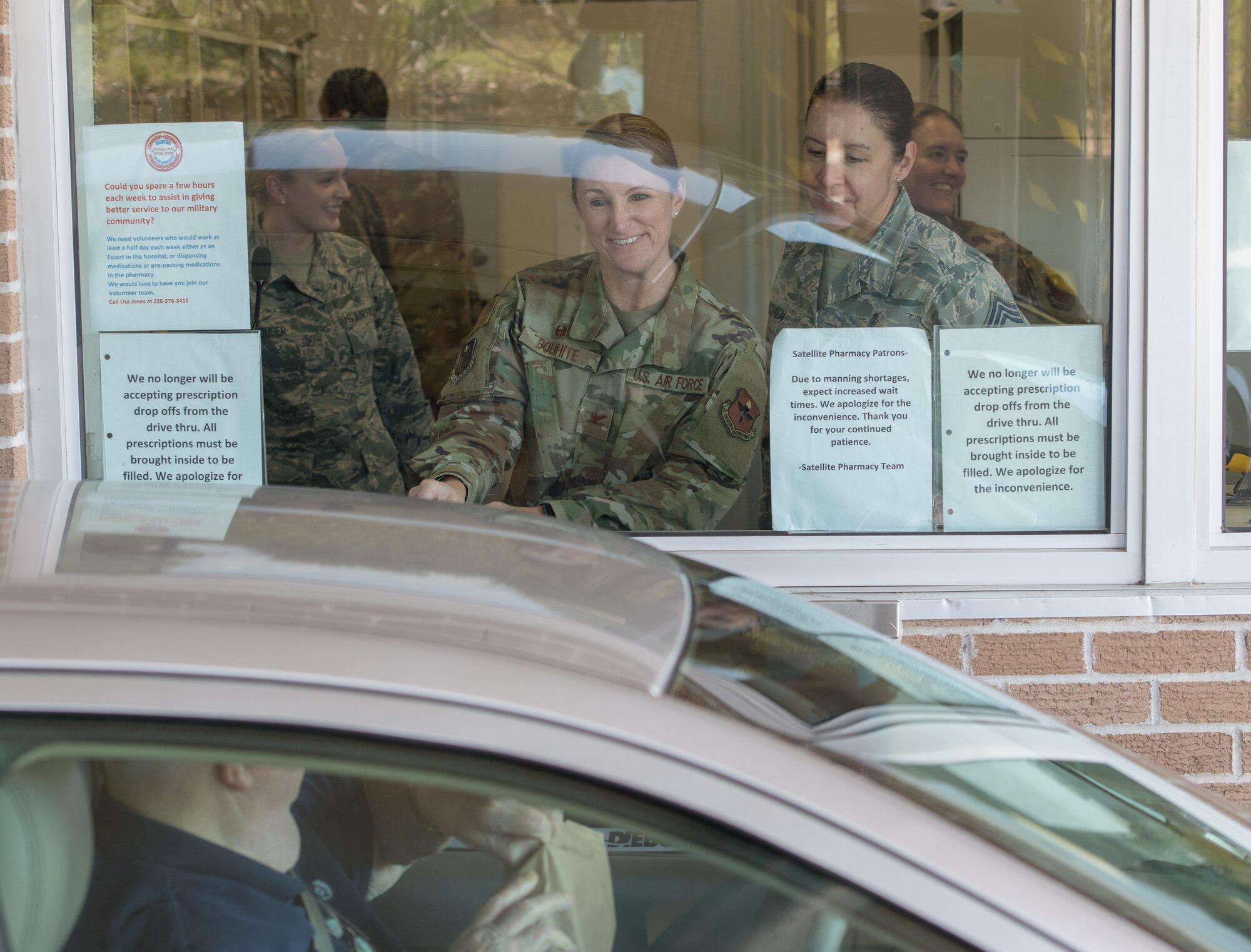 U.S. Air Force Col. Beatrice Dolihite, 81st Medical Group commander, issues filled prescriptions to a customer at the base exchange satellite pharmacy drive-thru window at Keesler Air Force Base, Mississippi, Oct. 8, 2019. The "Dragon Medic Experience" allowed the 81st MDG leadership to work side-by-side with group medics in order to understand the challenges and barriers they may face while providing care. It also allowed them to see first-hand the great ideas that the staff has implemented to focus on the patient experience. This experience helps us cultivate an environment where senior leadership has direct engagement and connection with our front line medics who strive to deliver outstanding care. (U.S. Air Force photo by Andre' Askew)