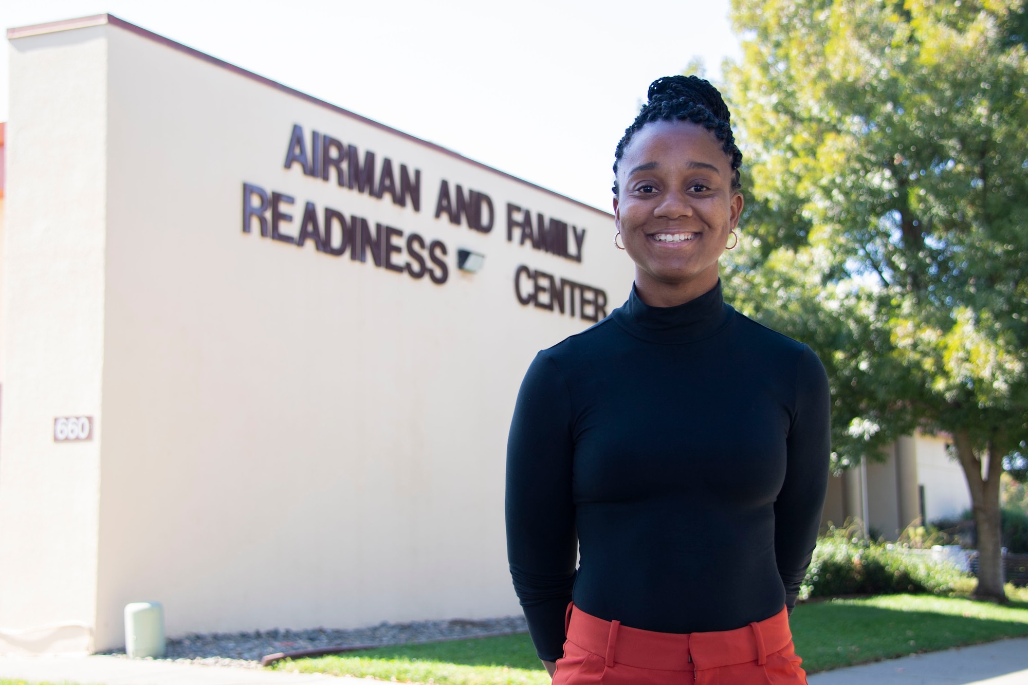 Teneika Mckoy, 60th Force Support Squadron readiness specialist, stands in front of the Airman and Family Readiness Center building