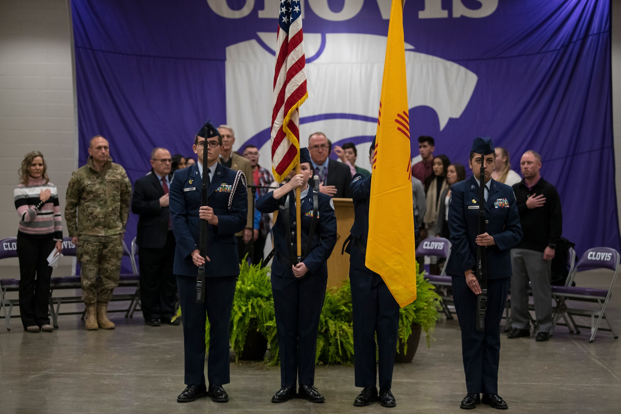 Members of the Clovis High School Junior Reserve Officers’ Training Corps stand during the national anthem at the National Math and Science Initiative program reveal at Clovis, N.M., Oct. 30, 2019. The program is a two-year College Readiness program, developed and implemented by NMSI. (U.S. Air Force photo by Senior Airman Vernon R. Walter)
