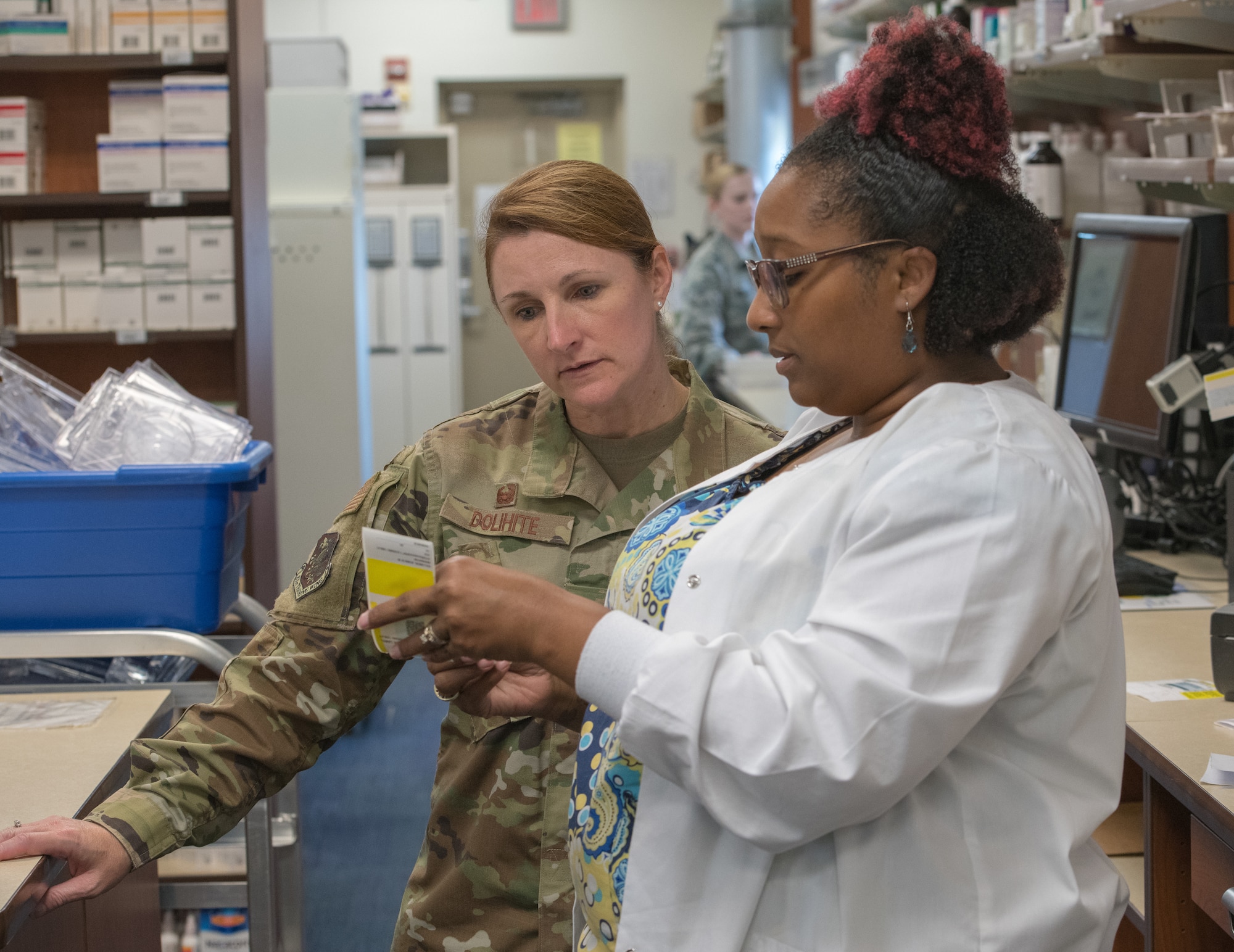 Nidra Bailey, 81st Diagnostic and Therapeutics Squadron vault custodian, briefs U.S. Air Force Col. Beatrice Dolihite, 81st Medical Group commander, on pharmacy procedures at the base exchange satellite pharmacy at Keesler Air Force Base, Mississippi, Oct. 8, 2019. The "Dragon Medic Experience" allowed the 81st MDG leadership to work side-by-side with group medics in order to understand the challenges and barriers they may face while providing care. It also allowed them to see first-hand the great ideas that the staff has implemented to focus on the patient experience. This experience helps us cultivate an environment where senior leadership has direct engagement and connection with our front line medics who strive to deliver outstanding care. (U.S. Air Force Photo by Andre' Askew)