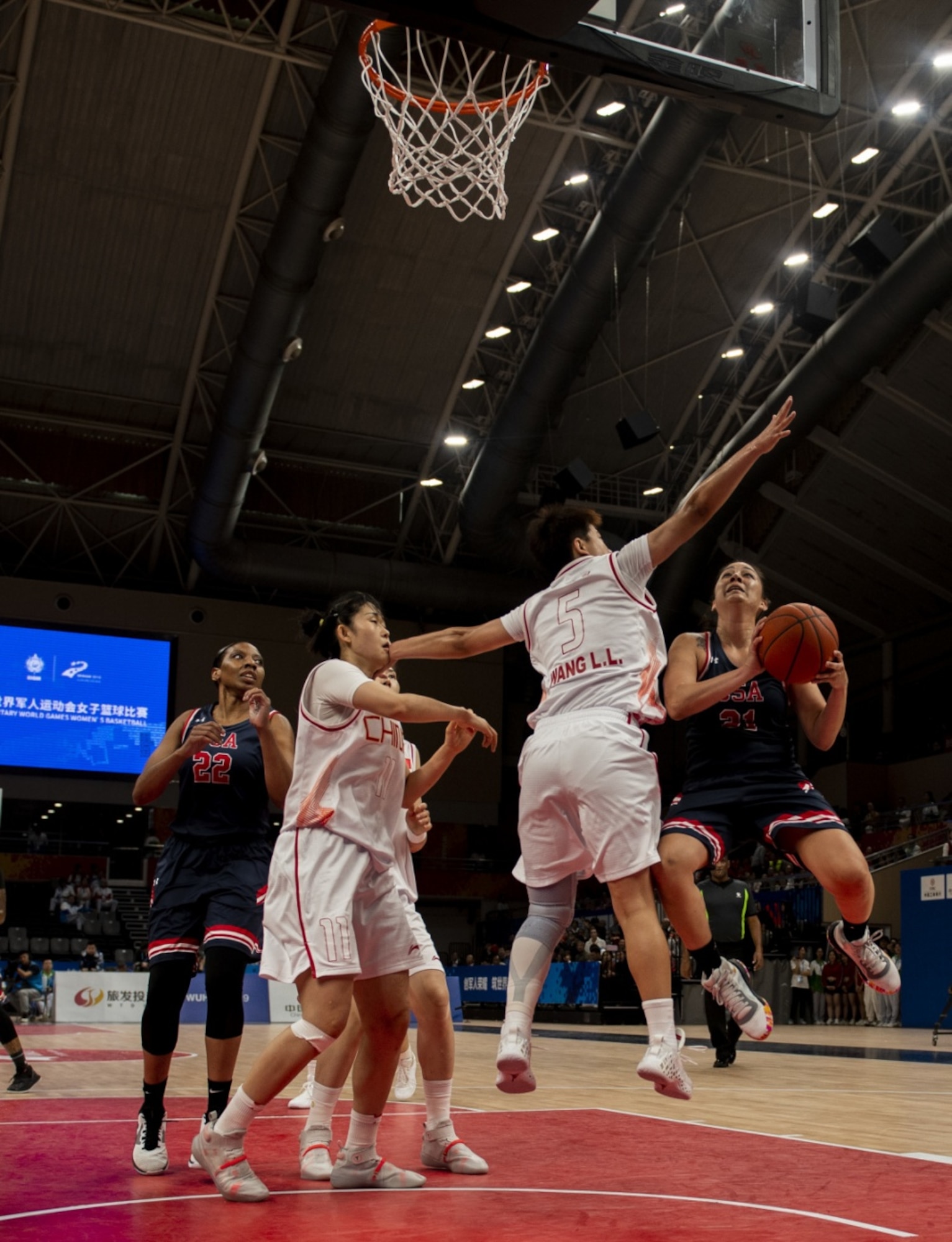 U.S. Air Force Reserve Citizen Airman Senior Airman Santia Jackson, United States Armed Forces Military World Games Women’s Basketball player, positions herself for a rebound as teammate Staff Sgt. Cinnamon Kava, drives past a Chinese defender for a layup during the Conseil International du Sport Militaire Women’s Basketball Competition in Wuhan China, Oct. 22, 2019. The 7th MWG will feature military athletes from around the world with an estimated participation of more than 100 nations and more than 10,000 participants. (U.S. Air Force photo by Staff Sergeant James R. Crow)