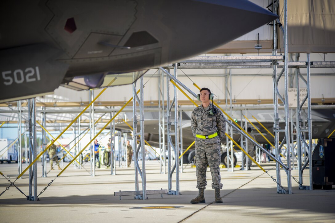 Airman 1st Class Dakota Smith, Assistant Dedicated Crew Chief, 31st Test and Evaluation Squadron, stands by as an F-35 Lightning II prepares to take off from Edwards Air Force Base, California, for the final time, Oct. 7. The 31st TES recently completed its initial operational test and evaluation mission and six F-35s were reassigned to the 422nd Test and Evaluation Squadron at Nellis Air Force Base, Nevada.  (U.S. Air Force photo by Giancarlo Casem)