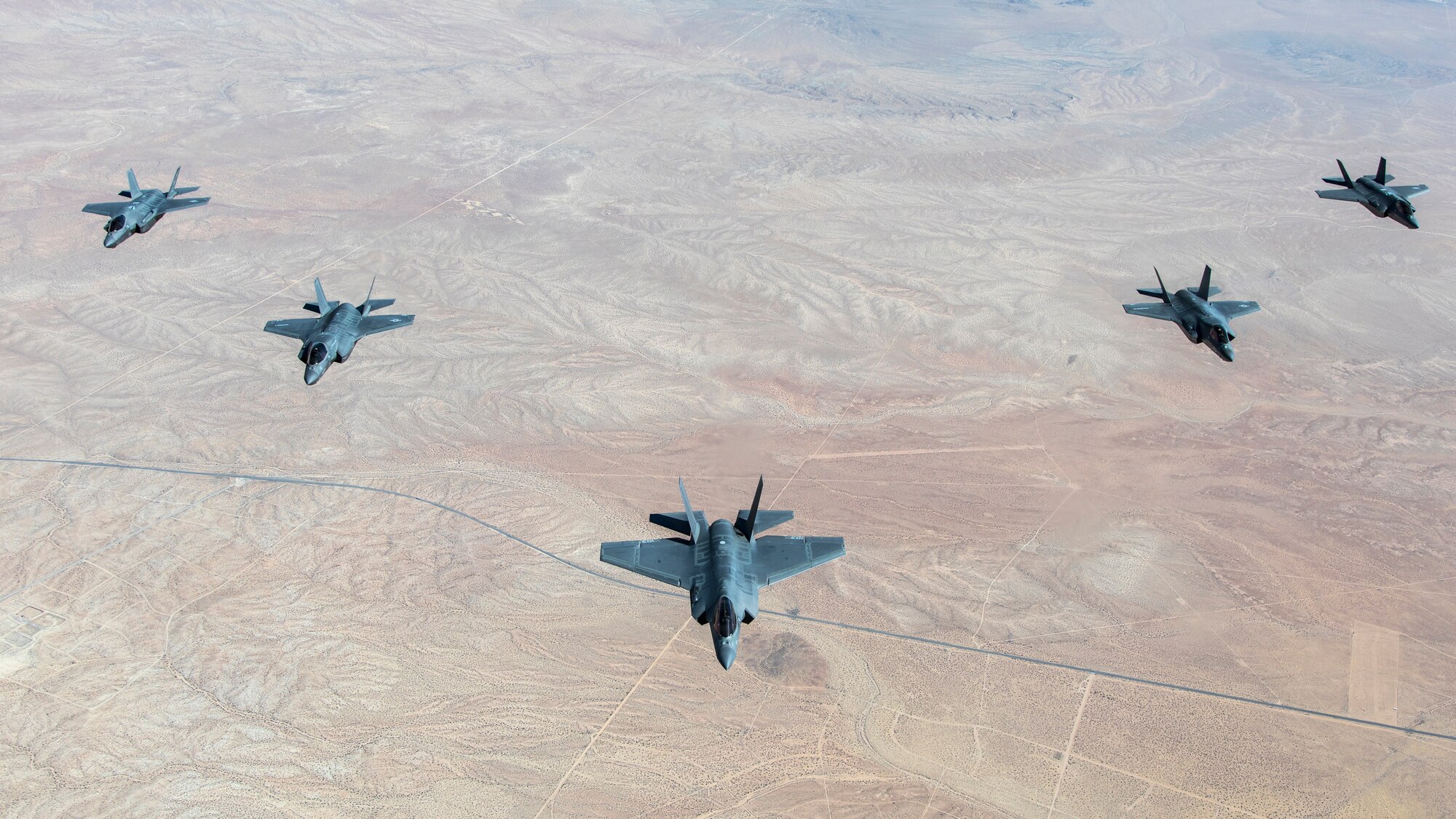A formation flight of F-35 Lightning IIs over Edwards Air Force Base, California. The 31st Test and Evaluation Squadron recently completed its initial operational test and evaluation mission and six F-35s were reassigned to the 422nd Test and Evaluation Squadron at Nellis Air Force Base, Nevada. (Photo courtesy of Darin Russell, Lockheed Martin)