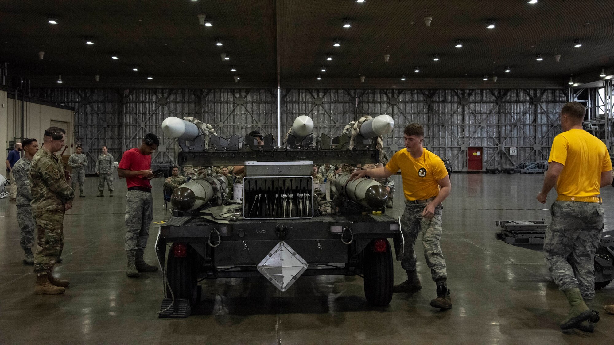 Airmen with the 13th and 14th Aircraft Maintenance Unit inspect inert munitions during the third quarter load competition at Misawa Air Base, Japan, Oct. 25, 2019.Weapon technicians evaluate participants on various aspects such as safety, accuracy, tool accountability and dress and appearance. The competition tested the ability of Airmen to quickly and precisely carry out the mission of power projection in the Indo- Pacific region. (U.S. Air Force photo by Airman 1st Class China M. Shock)