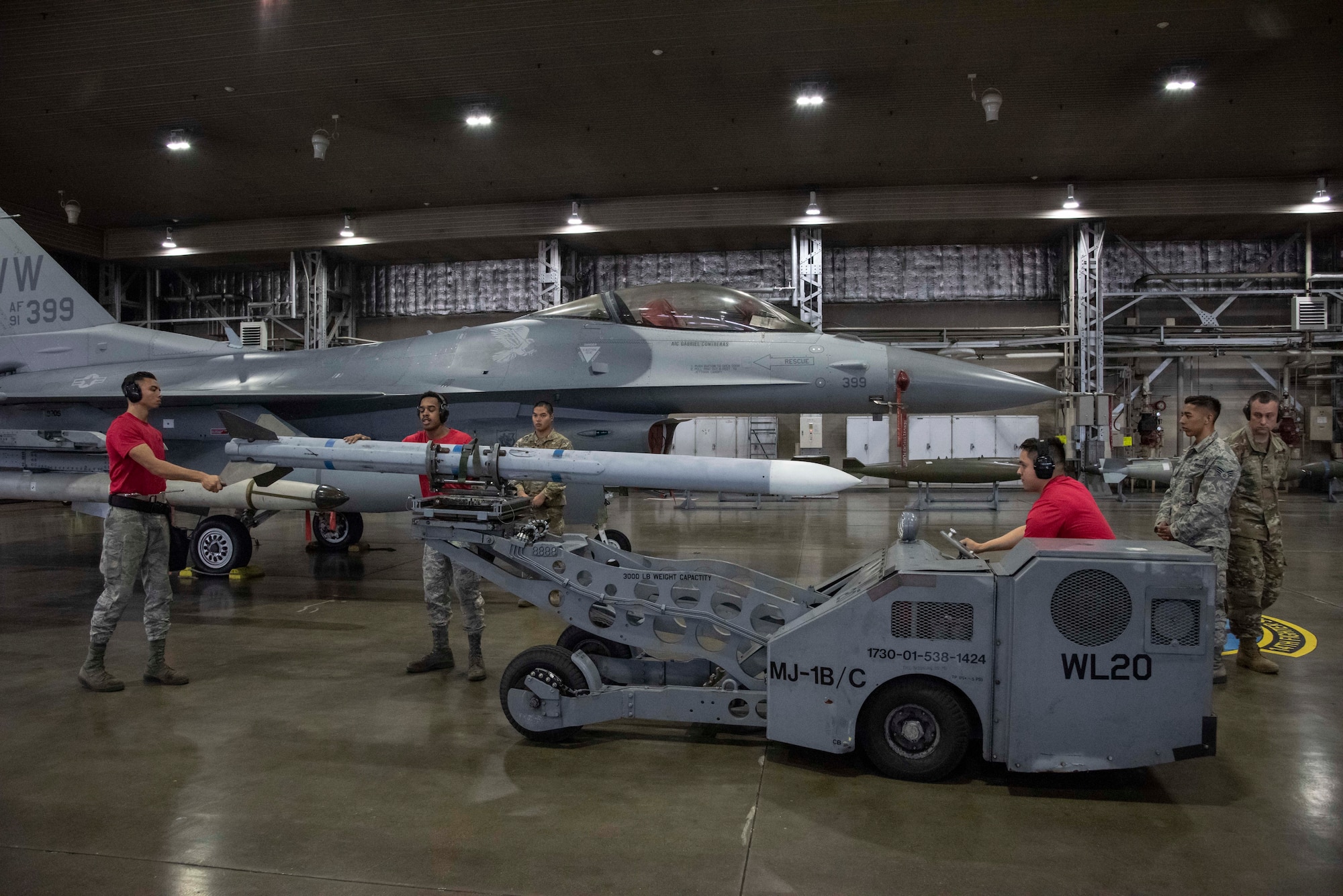 Airmen with the 13th Aircraft Maintenance Unit load munitions onto an F-16 Fighting Falcon during the third quarter load competition at Misawa Air Base, Japan, Oct. 25, 2019. Weapons load crew Airmen provide safe, reliable and effective aircraft and munitions to remain mission-capable and help deter our advisories in the Indo-Pacific region. (U.S. Air Force photo by Airman 1st Class China M. Shock)