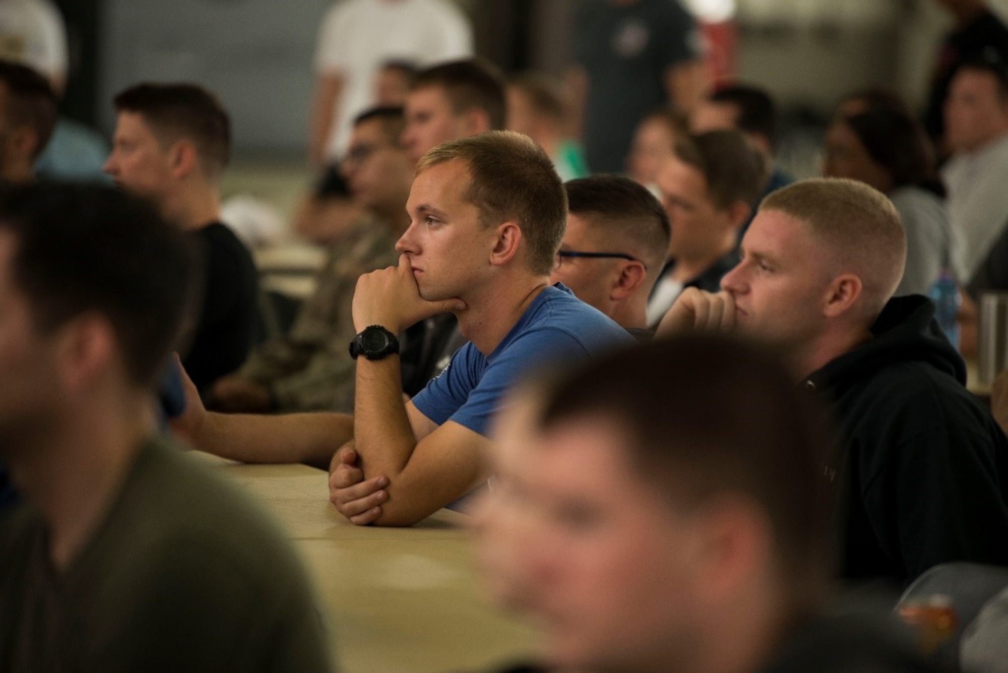 Airmen assigned to the 521st Air Mobility Operations Wing listen to guest speakers Capt. John Arroyo and Dr. Dave Roever on Sept. 15, 2019 at Ramstein Air Base, Germany. (U.S Air Force Photo by Senior Airman Sara Voigt)