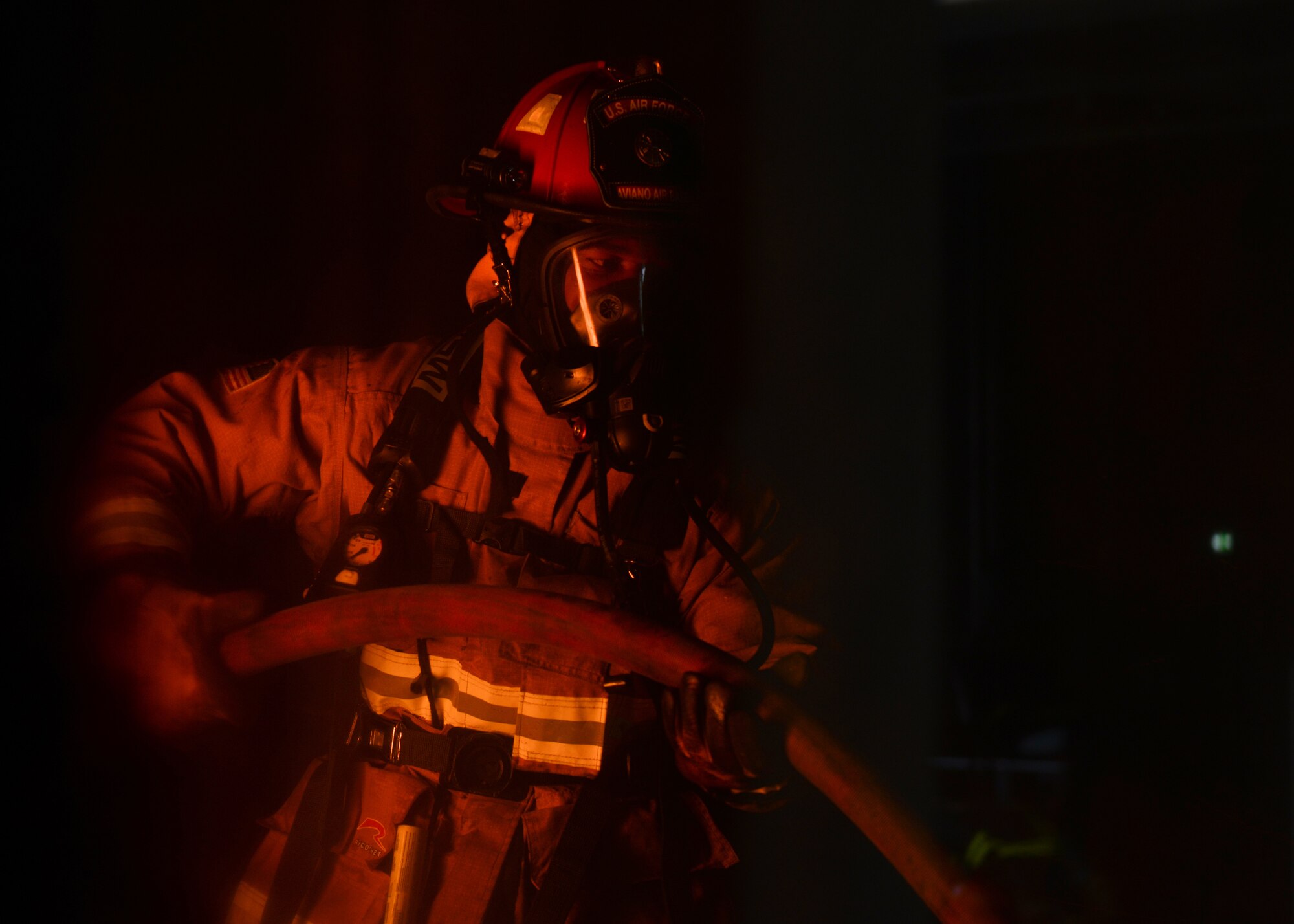 A U.S. Airman from the 31st Civil Engineer Squadron holds a hose in a live fire training exercise at Aviano Air Base, Italy, Oct. 29, 2019. The 31st CEF does live fire training three times every year. (U.S. Air Force Airman Thomas S. Keisler IV)