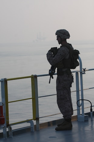STRAIGHT OF HORMUZ (Oct 24, 2019) A Marine assigned to Fleet Anti-Terrorism Security Team, Central Command (FASTCENT), stands watch on the Arc Liberty, a Military Sealift Command time chartered vessel, while providing security during a Strait of Hormuz transit. FASTCENT Marines work with U.S. partners and allies to protect personnel and property while simultaneously ensuring freedom of navigation in international waterways. Task Force 51 and 5th Marine Expeditionary Brigade is entrusted with rapidly aggregating crisis response capabilities and positioning Navy and Marine Corps forces throughout the U.S. Central Command area of responsibility to ensure command and control of forces at sea, from the sea, and ashore. (Photo by Marine Corps Cpl. Tanner A. Gerst)