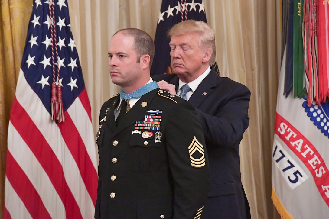 President Donald J. Trump presents Army Master Sgt. Matthew Williams with the Medal of Honor .