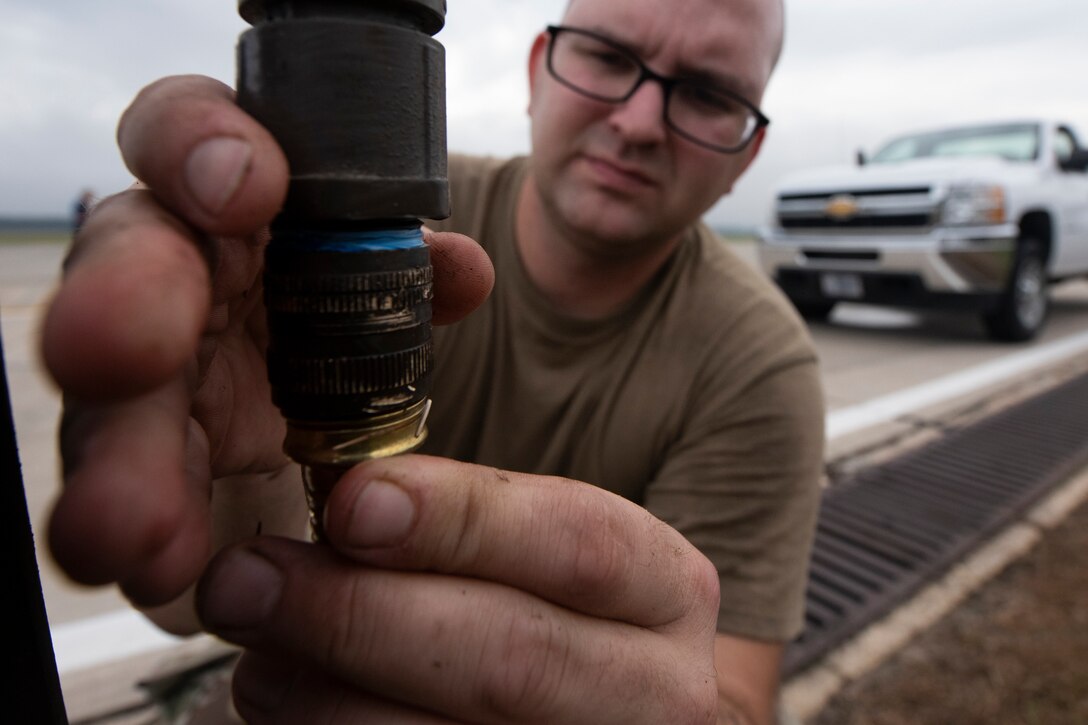 Staff Sgt. Douglas Shaw, 23d Civil Engineer Squadron (CES) water and fuel systems maintenance journeyman, connects a water hose to a water fountain Oct. 29, 2019, at Moody Air Force Base, Ga. The 23d CES installed water fountains around the flightline in preparation for the air show. This will give air show attendees locations for clean water and help with dehydration related injuries. (U.S. Air Force photo by Airman Elijah Dority)