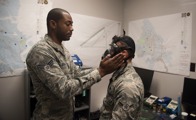 Senior Airman Chevyn Bryant, a bioenvironmental engineer technician assigned to the 628th Operational Medical Readiness Squadron, checks for air leaks while fitting a gas mask for Airman Juan Barragan, assigned to the 437th Airlift Wing, Oct. 24, 2019, at Joint Base Charleston, S.C. The 628th Bioenvironmental Engineering Flight uses three different types of masks for fit tests; a Mind Safety Appliance FireHawk first responder’s masks, a Minnesota Mining and Manufacturing full face industrial respirators and M50 gas masks.
