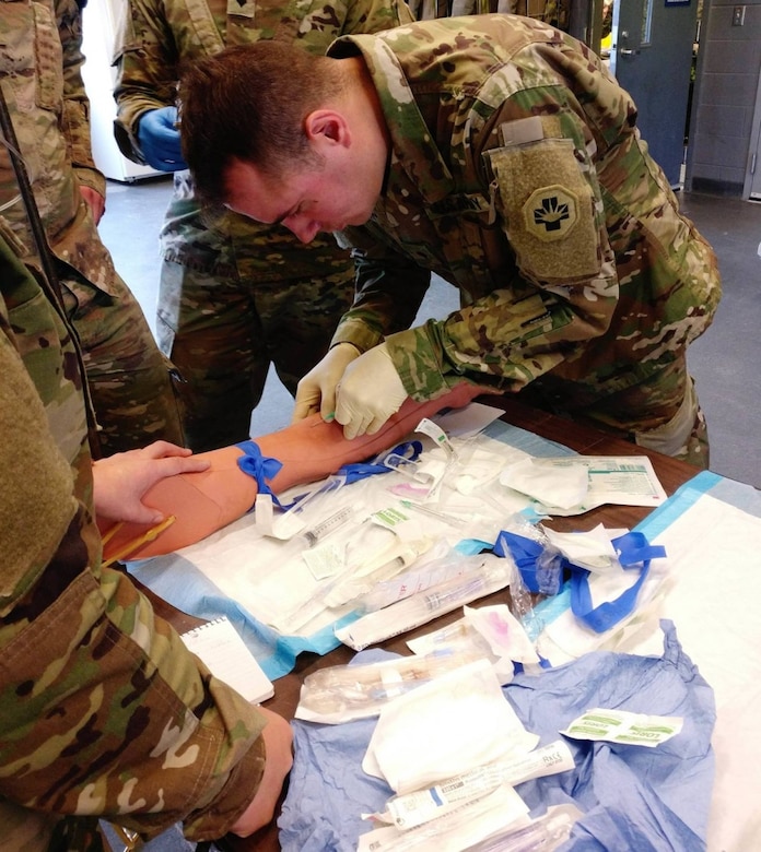Spc. Jeffrey Theisen administers an IV at the St Luke’s Field Ambulance Validation Event, hosted by the Canadian Armed Forces, 25 Field Ambulance, in Toronto, Ontario, Oct. 26th. Teams were comprised of 1 Officer, 1 NCO, and 3 junior Soldiers.