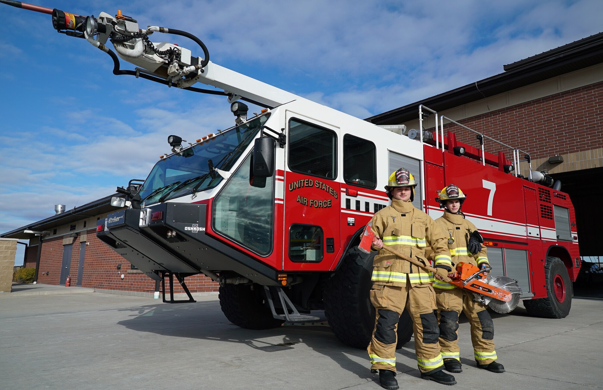 Firefighters with the 319th Civil Engineer Squadron, Airman 1st Class Hunter Garibay, left, and Airman 1st Class Sydney King, pose for a photo on National First Responders Day, Oct. 28, 2019, on Grand Forks Air Force Base, North Dakota. Garibay and King, new firefighters in the Air Force, expressed their drive to learn more and prepare themselves as potential heroes in a crisis situation. (U.S. Air Force photo by Senior Airman Elora J. Martinez)