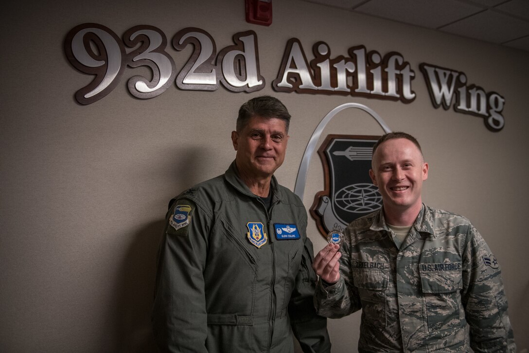 Col. Glenn Collins, 932nd Airlift Wing commander, stands with Airman 1st. Class Jeremy Zirkelbach, 932nd Maintenance Squadron crew chief, after presenting Zirkelbach with a Wing coin for his Airman’s Story presentation Oct. 18, 2019, Scott Air Force Base, Illinois.  Each month an Airman shares their Air Force story with Wing leadership during the Wing review briefing. (U.S. Air Force photo by Christopher Parr)