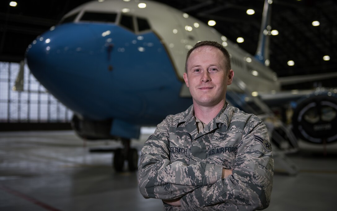 Airman 1st. Class Jeremy Zirkelbach, a 932nd Maintenance Squadron crew chief, poses with a C-40 as a backdrop, Oct. 30, 2019 inside Hangar 1, Scott Air Force Base, Illinois. Zirkelbach was selected by his leadership as the Airman Spotlight for October.  Each month an Airman shares their Air Force story with Wing leadership during the Wing review briefing. (U.S. Air Force photo by Christopher Parr)