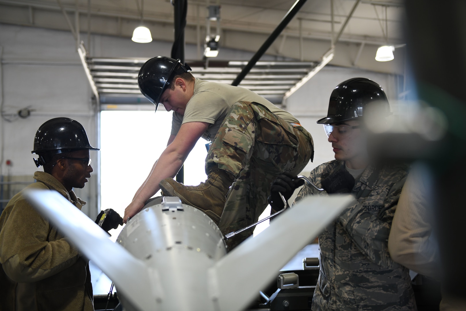 Airmen from the 28th Munitions Squadron separate a Joint Direct Attack Munition (JDAM) from its tail kit during a U.S. Strategic Command exercise on Ellsworth Air Force Base, S.D., Oct. 21, 2019. Global Thunder is an annual command and control exercise that provides training opportunities for all of U.S. Strategic Command’s mission areas, tests joint and field training operations, and has a specific focus on nuclear readiness. (U.S. Air Force photo by Airman 1st Class Christina Bennett)