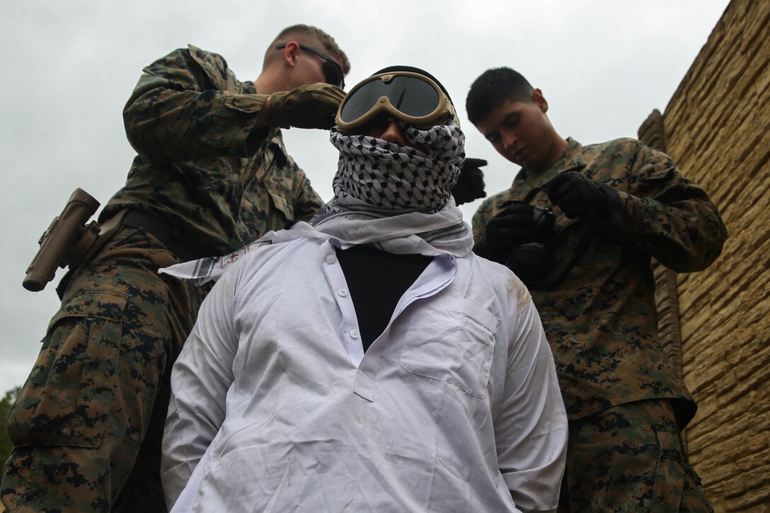 U.S. Marines with 2nd Law Enforcement Battalion, II Marine Expeditionary Force Information Group, conduct a detainee drill during a field exercise at Camp Lejeune, N.C., Oct. 22, 2019. The purpose of the training was to promote law and order in support of Marine Air Ground Task Force operations. Their training included day and night patrols, tactical site exploitation, detainee operations and identity operations. (U.S. Marine Corps photo by Cpl. Stephen Campbell)