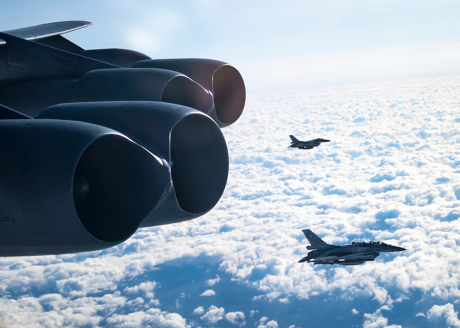 Two Polish Air Force F-16C Fighting Falcons engage in a planned intercept of a U.S. Air Force B-52H Stratofortress over Poland during Global Thunder 20, as part of a Bomber Task Force mission, Oct. 28, 2019. Global Thunder is an exercise that focuses on U.S. Strategic Command and component forces' ability to support the geographic combatant commands, deter adversaries and improve interoperability with joint partners and allied nations. (U.S. Air Force photo by Airman 1st Class Duncan C. Bevan)