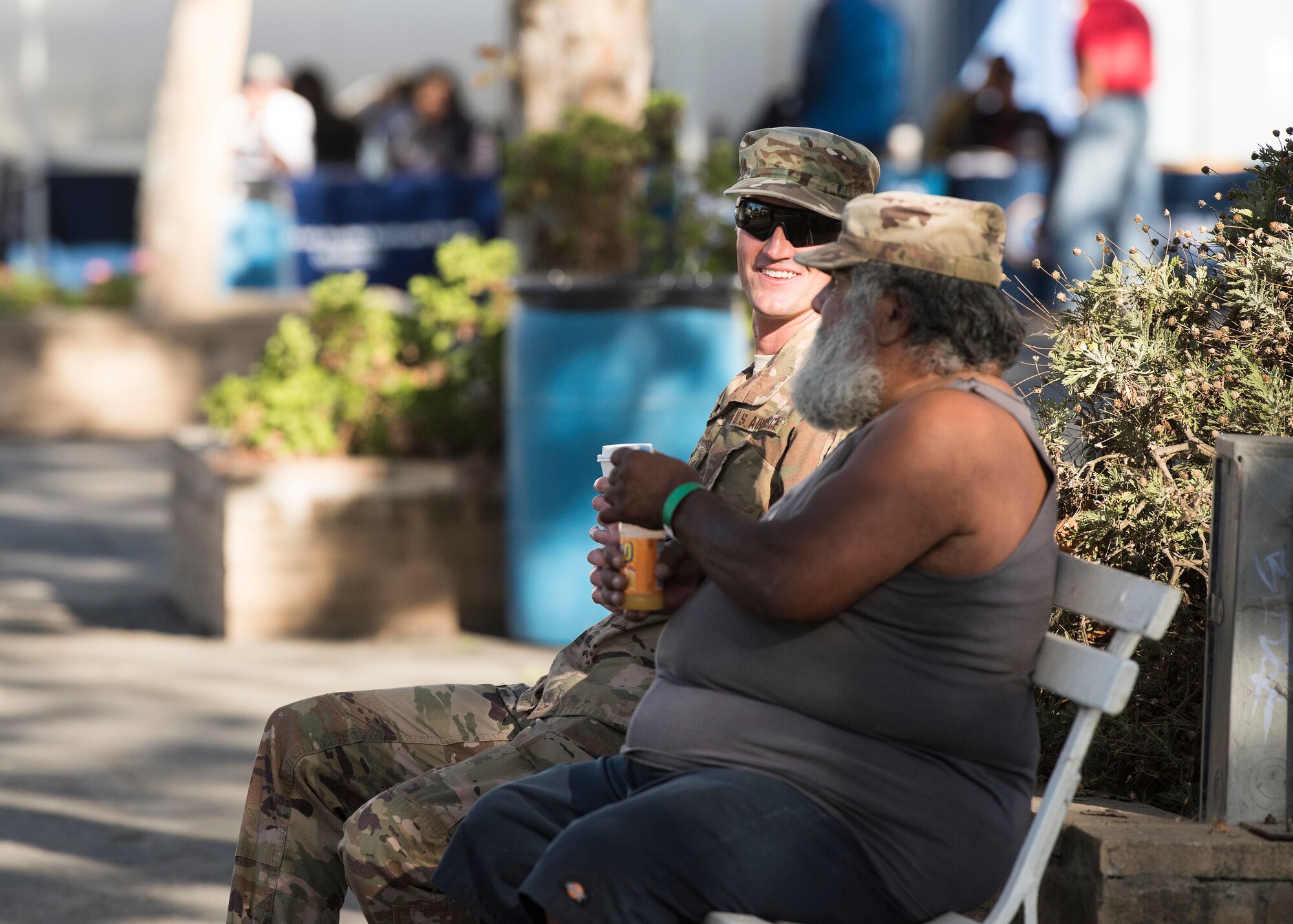 Staff Sgt. Robert Gross, 30th Civil Engineering Squadron utility outage administrator, visits with a homeless veteran during the 2019 Santa Barbara County Veteran Stand Down event Oct. 19, 2019, in Santa Maria, Calif. During the event, Airmen from Vandenberg Air Force Base, Calif. escorted veterans, offering them assistance carrying supplies, and serving as link between prior and current military. (U.S. Air Force photo by Airman 1st Class Hanah Abercrombie)