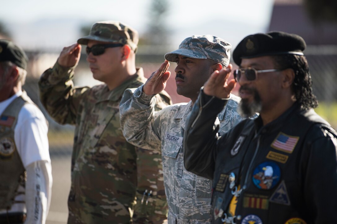 Active duty military members and veterans salute as the national anthem is played during the opening of the 2019 Santa Barbara County Veteran Stand Down Oct. 19, 2019, in Santa Maria, Calif. The Veteran Stand Down is an annual event dedicated to helping homeless veterans, veterans and the family of veterans by providing them with an array of services, food and the opportunity to connect with other veterans and active duty members. (U.S. Air Force photo by Airman 1st Class Hanah Abercrombie)
