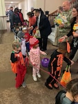 Defense Logistics Agency employees greet trick or treaters from the Stars and Stripes Learning Center as they celebrate Halloween in the Hart-Dole-Inouye Federal Center.