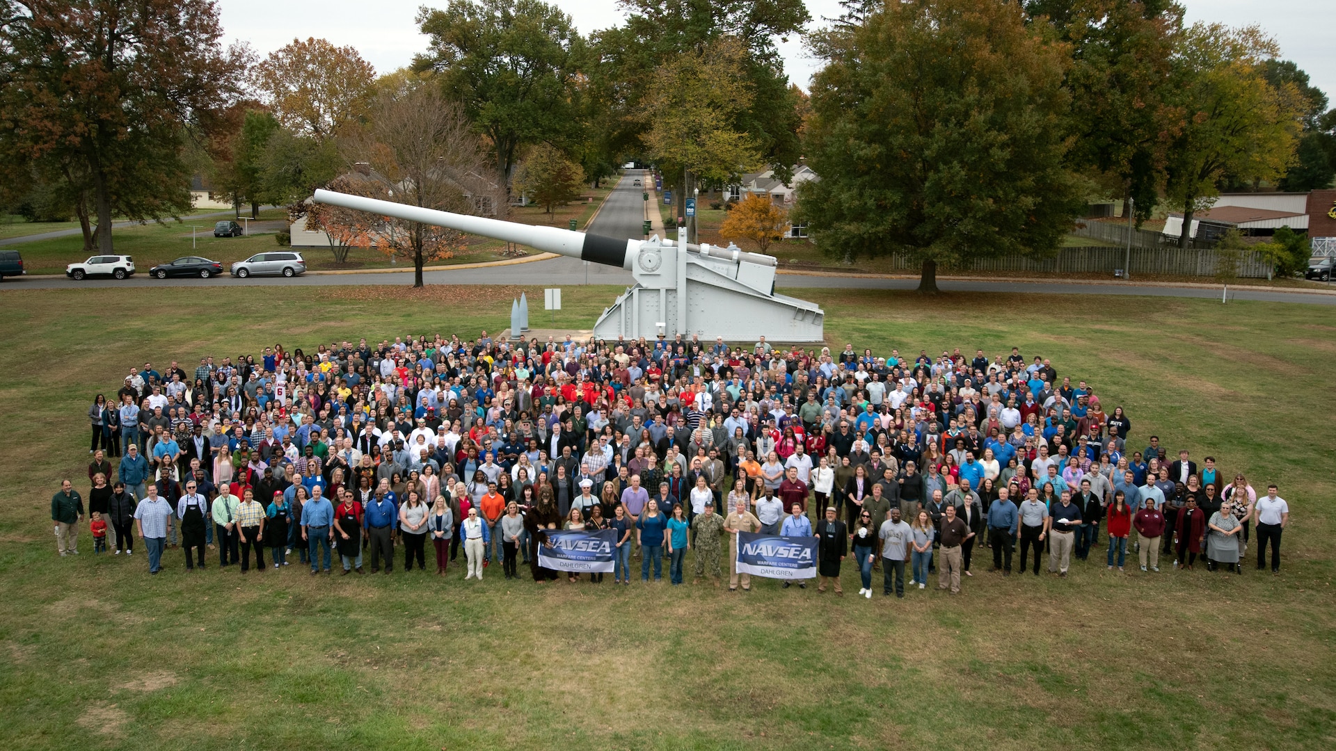 IMAGE: NSWC Dahlgren Division held a command picnic that featured lunch, music and sporting events at the parade field. Employees posed for a command photograph entitled "100 Years of NSWCDD Accomplishments" in front of the U.S. Navy 16-inch battleship gun.