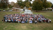 IMAGE: NSWC Dahlgren Division held a command picnic that featured lunch, music and sporting events at the parade field. Employees posed for a command photograph entitled "100 Years of NSWCDD Accomplishments" in front of the U.S. Navy 16-inch battleship gun.