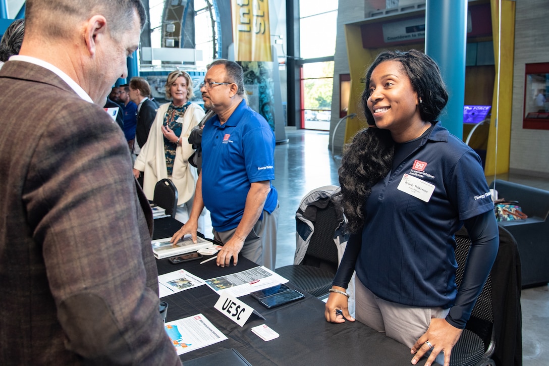 Brandy Wilkerson, a project manager with the Utility Energy Service Contracting program from the U.S. Army Engineering and Support Center, Huntsville, greets an attendee of the 2019 Small Business Forum at the U.S. Space & Rocket Center in Huntsville, Ala., Oct. 24, 2019. The event gave hundreds of business representatives an opportunity to connect face to face with Huntsville Center program and project managers and acquisition professionals.