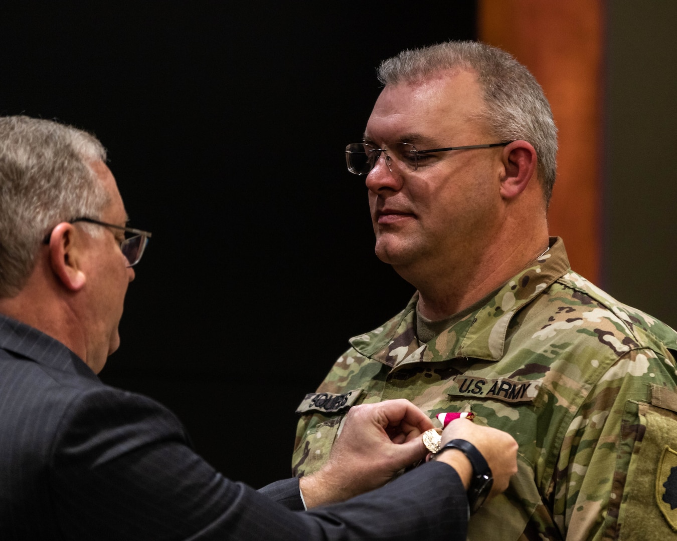 Joseph Schweickert, Director of Human Relations, Illinois National Guard, pins the Meritorious Service Medal to Master Sgt. Philip Squires during his retirement ceremony at Camp Lincoln, Springfield, Illinois, Oct. 30. Squires retired from the Illinois National Guard with 25 years of service. (U.S. Army Photo by Sgt. Stephen Gifford, Illinois National Guard Public Affairs)