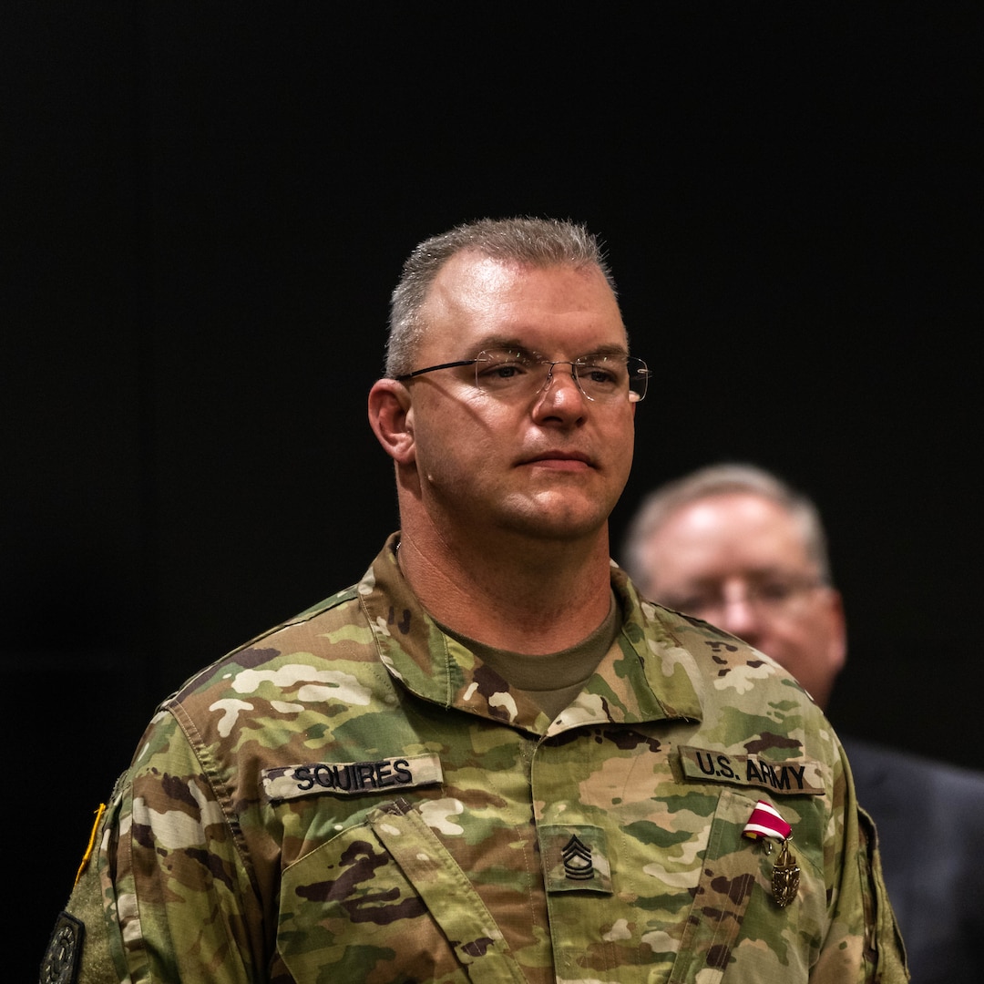 Joseph Schweickert, Director of Human Relations, Illinois National Guard, pins the Meritorious Service Medal to Master Sgt. Philip Squires during his retirement ceremony at Camp Lincoln, Springfield, Illinois, Oct. 30. Squires retired from the Illinois National Guard with 25 years of service. (U.S. Army Photo by Sgt. Stephen Gifford, Illinois National Guard Public Affairs)