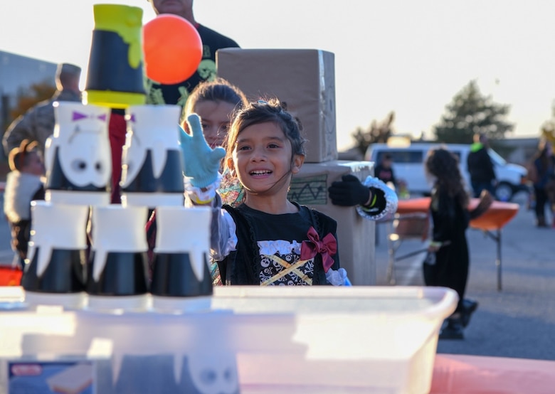 Arailey Sauceda, age 7, throws a ball at the Trunk or Treat Spooktacular event Oct. 25, 2019, at McConnell Air Force base, Kan.  The event featured free food, carnival games, pumpkin picking and the opportunity for children to participate in a costume contest. (U.S. Air Force photo by Airman 1st Class Nilsa E. Garcia)