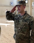 Staff Sgt. Gregory Baumgartner of Elmwood, Illinois, salutes his commanding officer after a promotion ceremony at the Urbana Readiness Center in Urbana Oct. 18.