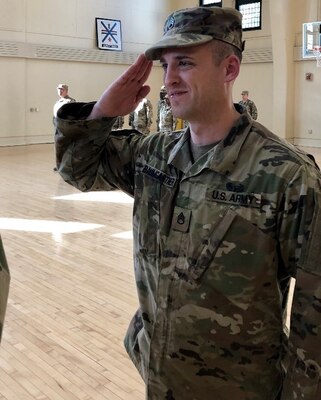 Staff Sgt. Gregory Baumgartner of Elmwood, Illinois, salutes his commanding officer after a promotion ceremony at the Urbana Readiness Center in Urbana Oct. 18.