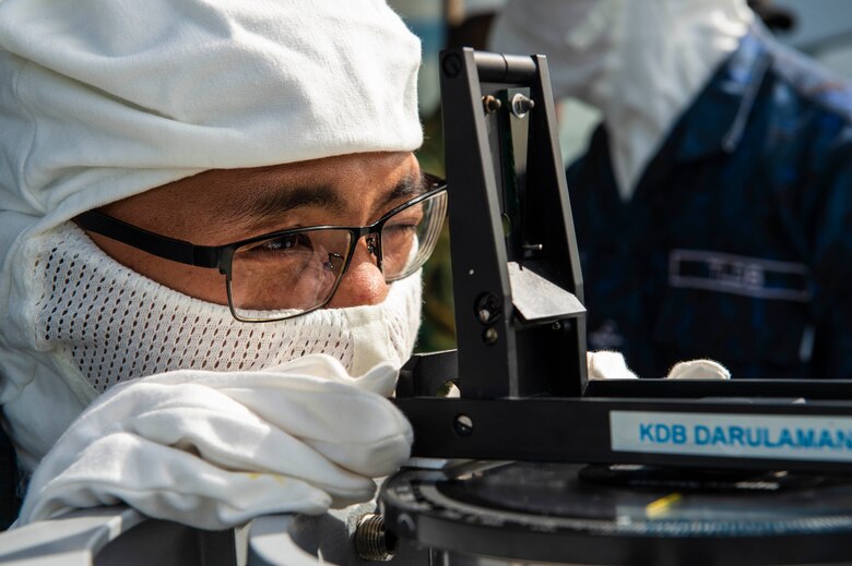 SOUTH CHINA SEA (Oct. 29, 2019) A Royal Brunei Navy sailor gathers bearing on a live-fire target during a gunnery exercise (GUNEX) in support of Cooperation Afloat Readiness and Training (CARAT) Brunei. This year marks the 25th iteration of CARAT, a multinational exercise designed to enhance U.S. and partner navies' abilities to operate together in response to traditional and non-traditional maritime security challenges in the Indo-Pacific region.