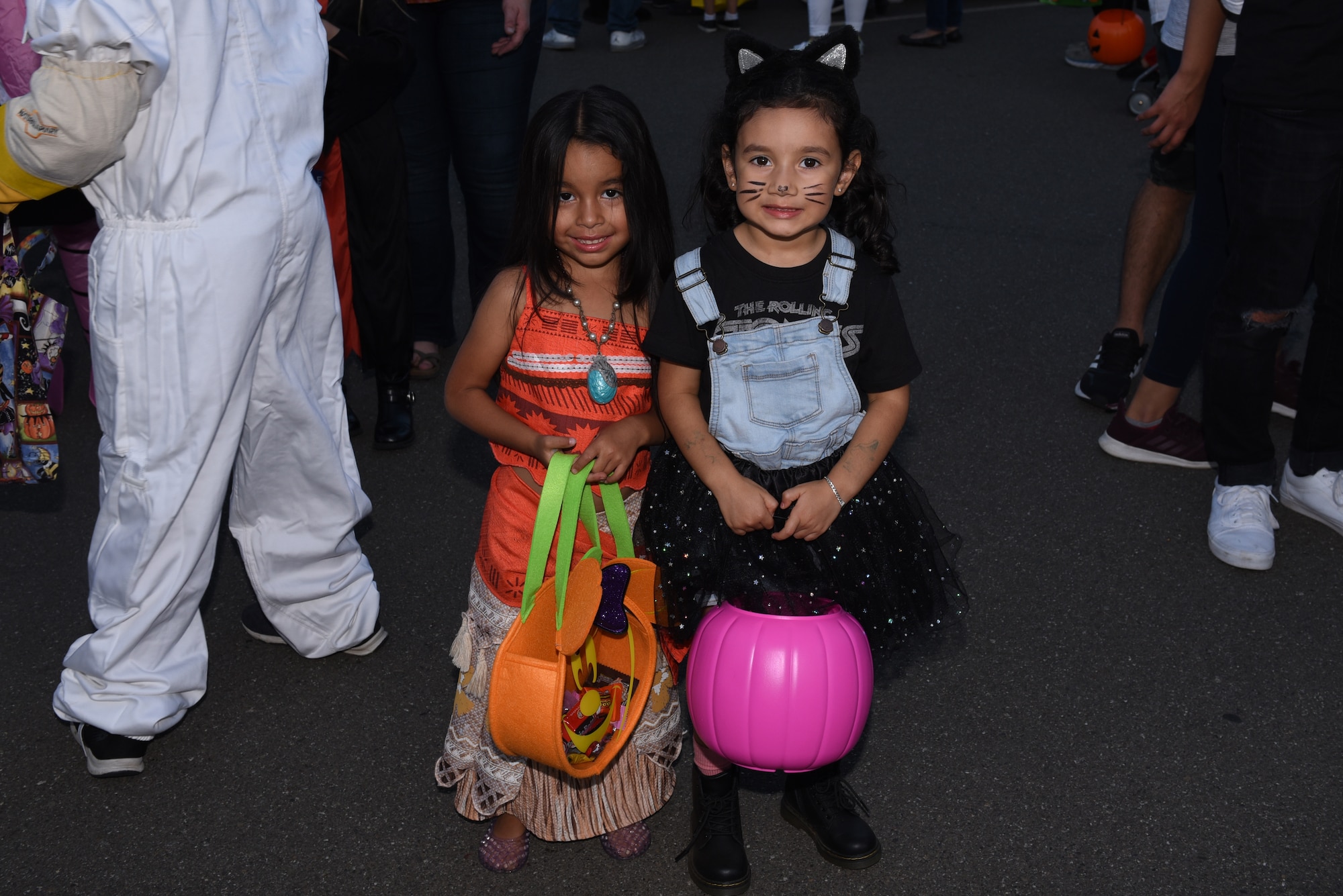 Berlyn Sanchez, left, daughter of U.S. Air Force Tech. Sgt. Marycruz Castro, 79th Air Refueling Squadron aviation resource manager, and Leia Reyes, right, daughter of Senior Airman Brenda Reyes, 349th Aerospace Medicine Squadron medical administrator, show off their Halloween costumes Oct. 25, 2019, at Travis Air Force Base, California. The Airman and Family Readiness Center hosted Trunk-or-Treat, an annual event aimed to provide a safe place for military families to enjoy Halloween festivities. The event had approximately 5,000 attendees and more than 60 vehicle trunks loaded with candy. (U.S. Air Force photo by Airman 1st Class Cameron Otte)