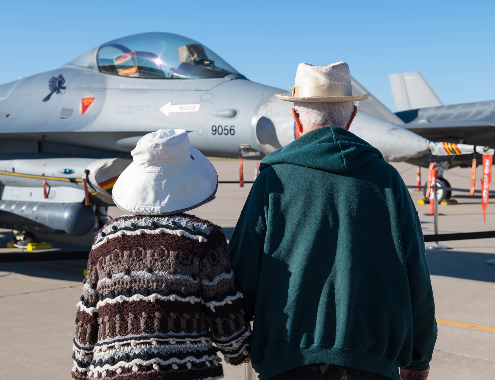 Two military retirees admire an F-16C Fighting Falcon during a Retiree Appreciation Day event Oct. 26, 2019, at Luke Air Force Base, Ariz.