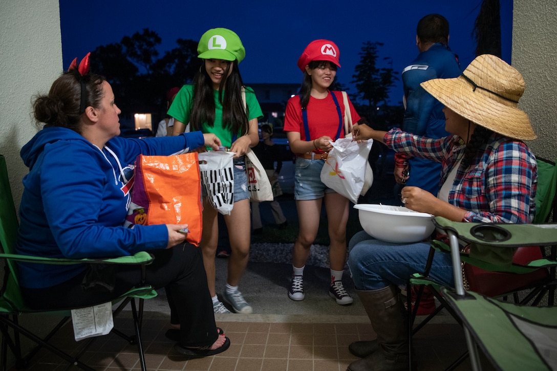 Okinawan children receive candy during a Halloween trick-or-treat event Oct. 31, 2019, on Kadena Air Base, Japan. Japanese residents participated in a cultural exchange allowing a portion of local communities to experience trick-or-treating with service members and their families. (U.S. Air Force photo by Senior Airman Rhett Isbell)