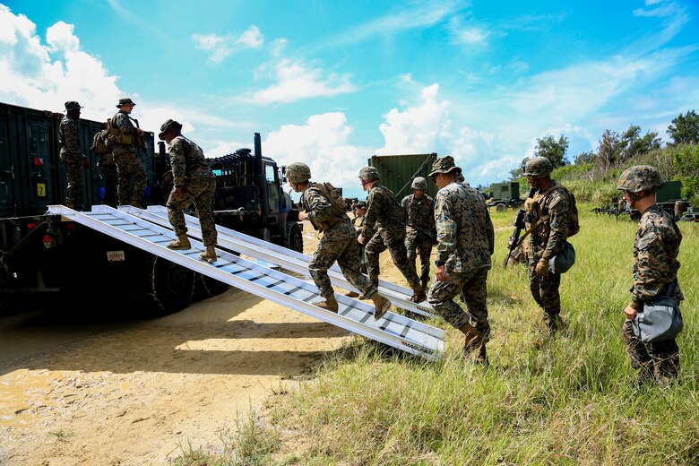 U.S. Marines with Headquarters Battalion, 3rd Marine Division, begin to offload a 7-ton vehicle during Samurai 20-1 on Camp Hansen, Okinawa, Japan, Oct. 22, 2019. The purpose of this exercise is to conduct battle drills that validate the 3rd Marine Division’s movement, setup of a combat operations center, force protection, and passage of command and control between supporting elements. (U.S. Marine Corps photo by Sgt. David Staten)