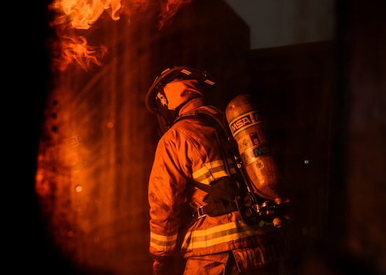 U.S. Senior Airman Jose Villalobos, 31st Civil Engineer Squadron fire protection journeyman, participates in a live fire training exercise at Aviano Air Base, Italy, Oct. 29, 2019. Live fire training is conducted in a burn building, which is a structure built to be intentionally burned for firefighter training. (U.S. Air Force photo by Airman Thomas S. Keisler IV)