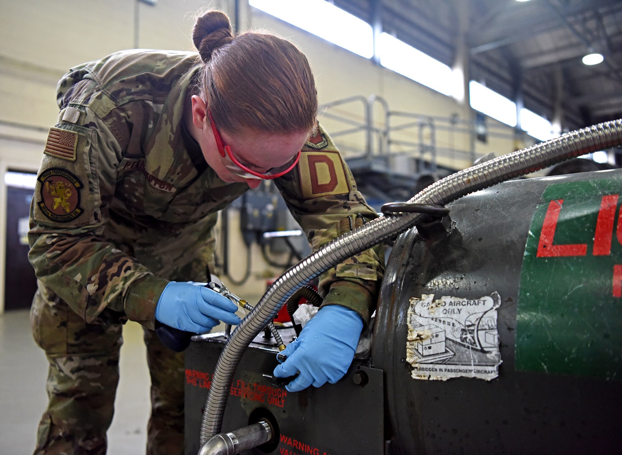 Airman 1st Class Rachael Pennington, 100th Maintenance Squadron aerospace ground equipment technician, lubricates a liquid oxygen tank at RAF Mildenhall, England, Oct. 23, 2019. AGE inspects hundreds of pieces of equipment which are essential to ensuring an aircraft’s mission readiness. (U.S. Air Force photo by Senior Airman Brandon Esau)