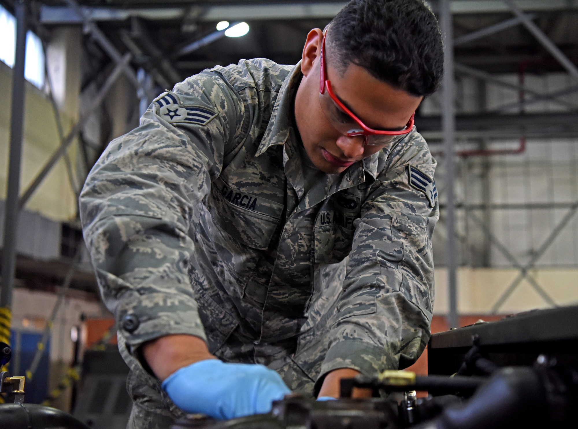 Senior Airman Antonio Garcia, 100th Maintenance Squadron aerospace ground equipment technician, repairs a ground power unit engine at RAF Mildenhall, England, Oct. 23, 2019. Repairs, updates and inspections are conducted on aerospace ground equipment to ensure everything is in proper working order. (U.S. Air Force photo by Senior Airman Brandon Esau)